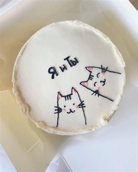 A Cake Decorated With Two Cats On It