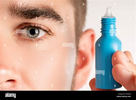 Male Eye And Small Bottle Of Eyedrops Stock Photo Alamy