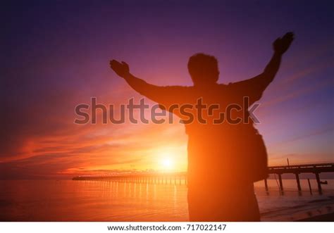 Silhouette Man Hands Raised Beautiful Sunrise Stock Photo