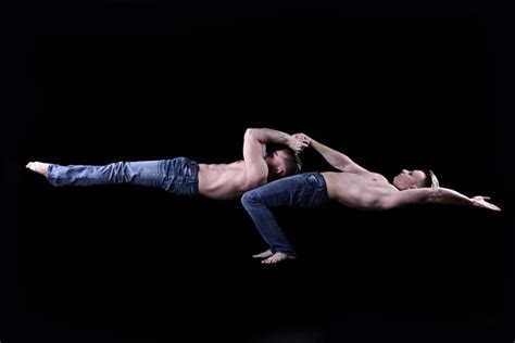 Premium Photo Two Twin Brothers In Blue Jeans With A Naked Torso Perform Acrobatic Elements