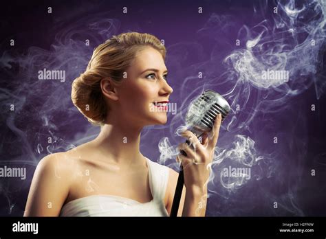 Beautiful Blonde Woman Singer With A Microphone Stock Photo Alamy