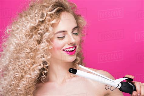 Beautiful Smiling Naked Woman Holding Hair Curler Isolated On Pink Royalty Free Stock Photo