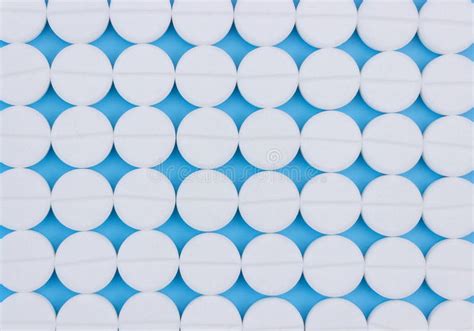 Texture From White Medical Pills On A Blue Background Template For