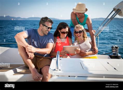 Croatia Adriatic Sea Young People On Sailboat Using Tablet Stock