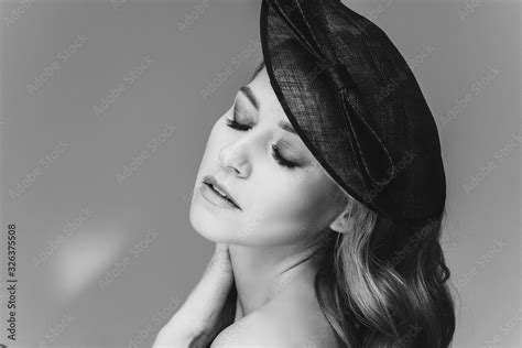 Studio Portrait Of An Immaculate Lady With Natural Makeup Blonde Wavy Hair And Blue Eyes