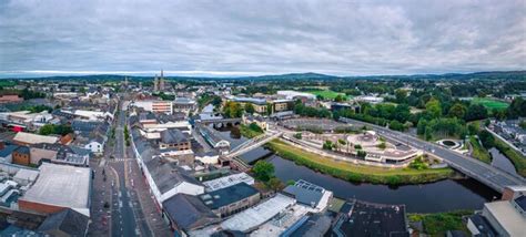 premium photo aerial view  cityscape omagh surrounded  dense trees