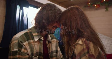 Close Up Shot Of A Romantic Scene A Brunette Guy In A Green Checkered Shirt Rubs His Forehead