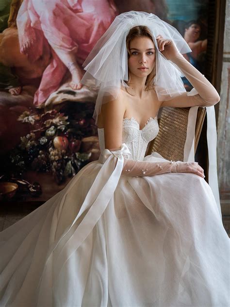 Mini wedding dress with detachable sleeves and overskirt