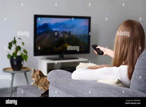 Woman in sofa zapping tv hi-res stock photography and images - Alamy