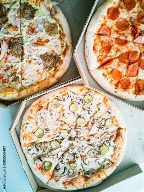 Online food ordering and food delivery. Pizza in boxes. Stock Photo ...