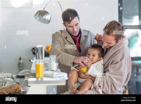 Gay Couple Feeding Son Breakfast Stock Photo Alamy