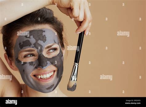 Smiling Modern 40 Years Old Woman With Brush And Cosmetic Mask Isolated