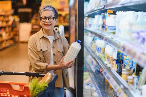 Buy Milk At The Supermarket Please - Woman buying milk in supermarket dairy aisle 78813989 Stock Photo at ...