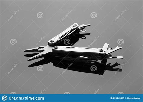 Compact Portable Metallic Multitool On Grey Table Stock Image Image