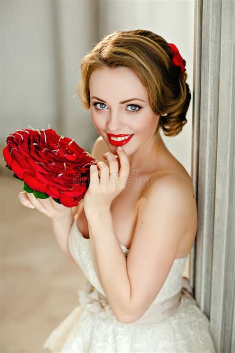 Charming Blonde Girl With Beautiful Smile In A White Lace Dress Stock