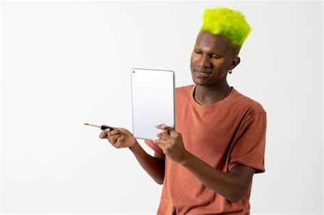 Premium Photo A Gay Black Ethnic Man Putting On Makeup Lgtbi Concept Portrait Correcting Dark