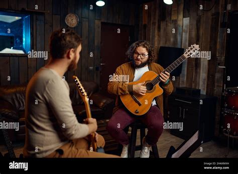 Music Tutor Explaining Features Of Playing Guitar Stock Photo Alamy