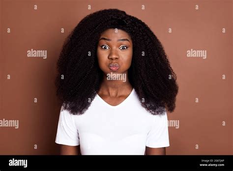 portrait  carefree dark skin lady holding air cheeks  camera good