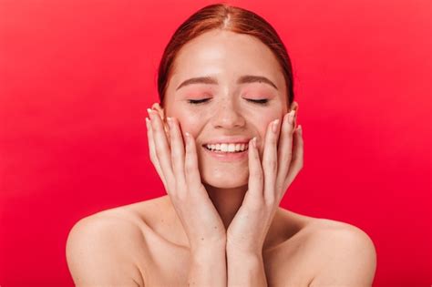 Free Photo Front View Of Cheerful Ginger Girl Touching Face Studio Shot Of Excited Nude Woman