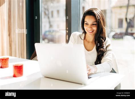 Beautiful Brunette Using Notebook In Cafe Stock Photo Alamy