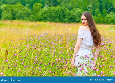 Portrait Of A Beautiful Brunette In A Field Of Purple Flowers Stock Image Image Of Cheerful