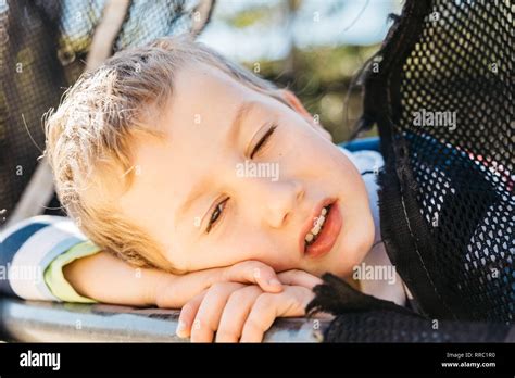 Blonde Year Old Twink Looking At Camera With Tired Face And Taking A Nap For Being Sleepy