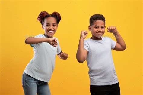 Positive black children dancing over yellow background Stock Photo by ...