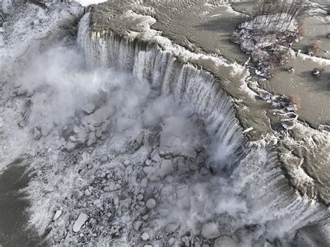 Tourists flock to frozen Niagara Falls as Buffalo’s devastating storm