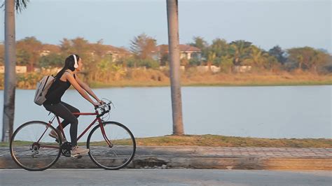 Happy Young Asian Woman While Riding A Bicycle In A City Park She Smiled Using The Bicycle Of