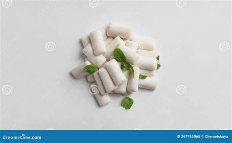 Tasty Chewing Gums And Mint Leaves On White Background Flat Lay Stock