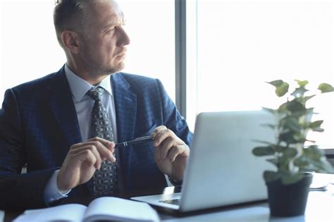 Premium Photo Focused Mature Businessman Deep In Thought While