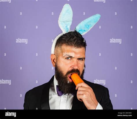 Easter Bunny Man Nibbles A Carrot Like A Hare Healthy Man On Holiday