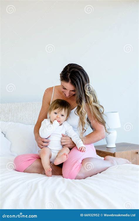 Smiling Brunette Woman Holding A Cute Baby Stock Photo Image Of Comforter Happiness 66932952