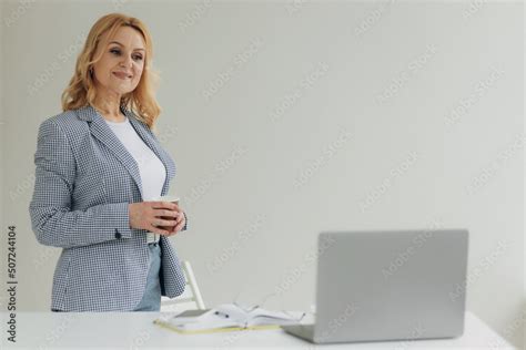 Portrait Mature Elegant Senior Elderly Female With Blonde Hair And Slim Fit Body Drinking Green