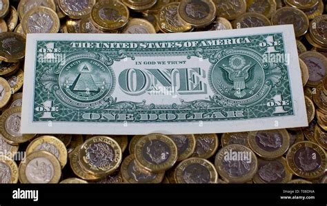 United States One Dollar Bill With The British 12 Sided One Pound Coins In The Background Stock