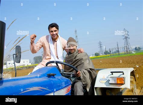 Farmer ploughing field Stock Photo - Alamy