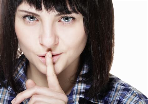 Premium Photo Portrait Of A Smiling Brunette Woman With A Finger On Her Lips