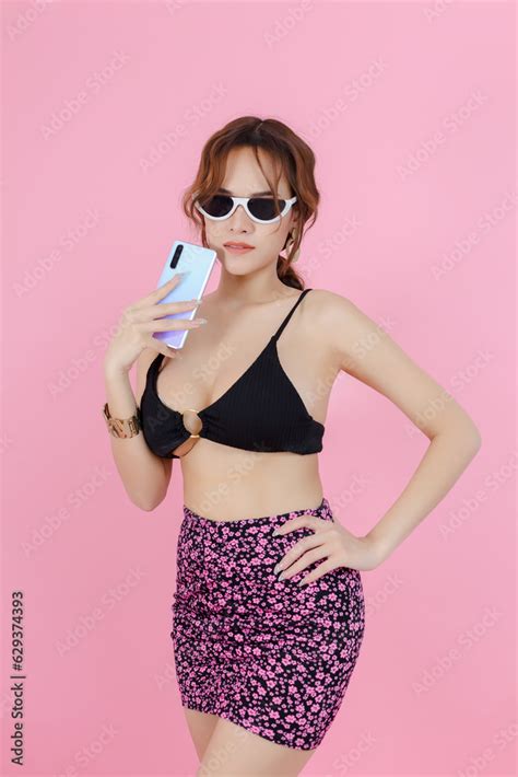 Sexy Beautiful Women In Underwear Bikini With Sunglass Holding Smartphone Pink Background