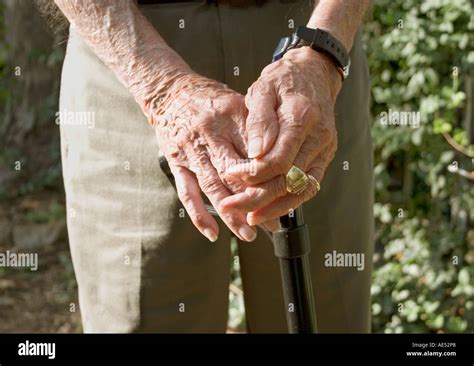 Elderly Masculine Hands Resting On A Cane Outdoors Stock Photo Alamy