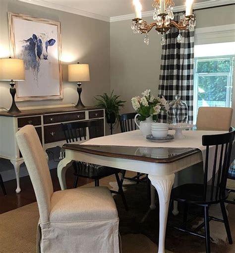 A Dining Room Table With Chairs And A Chandelier