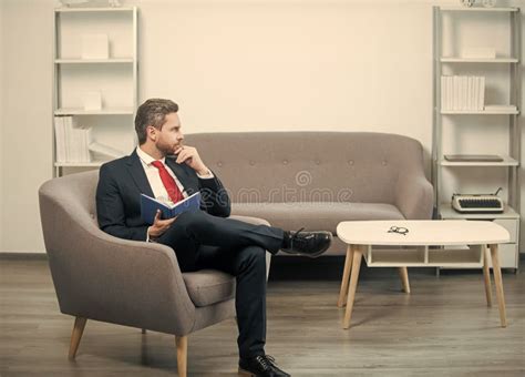 Mature Businessman In Suit Sit In Office Making Notes In Notebook Making Decision Stock Image