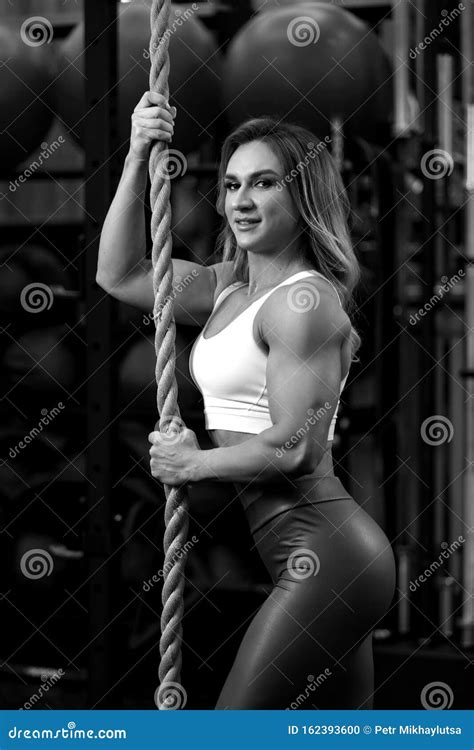 Blonde Bodybuilder Woman Is Standing With Rope In The Gym And Posing Bw