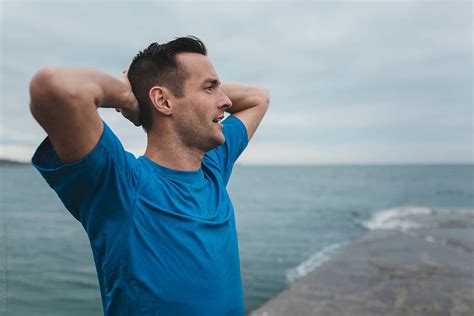 "Motivated Young Man Breathing Hard Outside On Cold Windy Day" by ...