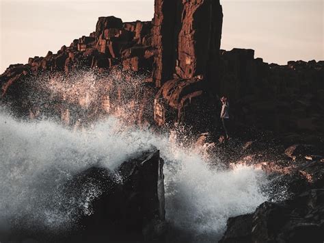 Premium Photo Waves Splashing On At Rocky Shore