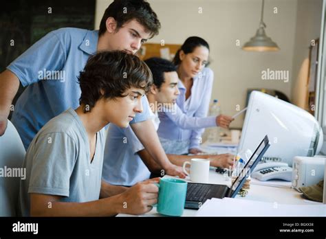 College Students Collaborating Together Using Computers Stock Photo Alamy