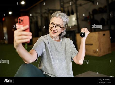 Merry Pretty Mature Woman In Gray T Shirt With Glasses Taking Selfies