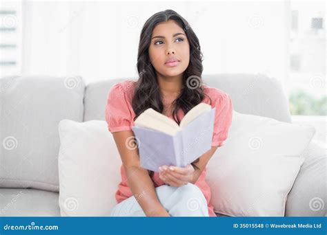 Thoughtful Cute Brunette Sitting On Couch Reading A Book Stock Photo Image Of Domicile Cute