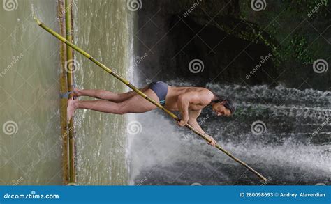 A Man With A Naked Torso On A Wooden Raft Near A Waterfall Vertical Video Stock Video Video
