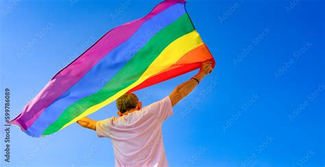 Mature Man Holding Colorful Lgbt Rainbow Flag Raising Up Into The Air The Meaning Of Freedom
