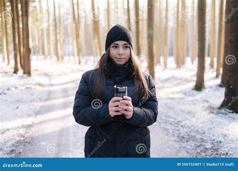Portrait Of Beautiful Female In Snowy Forest Woman Hold In Hands Thermos With Hot Tea Stock